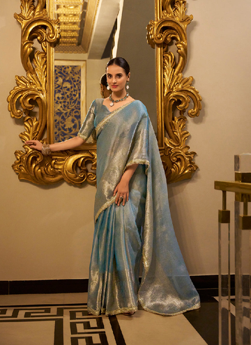 Party wear Sky Blue Tissue shimmer saree with zari weaving and sequin lace.